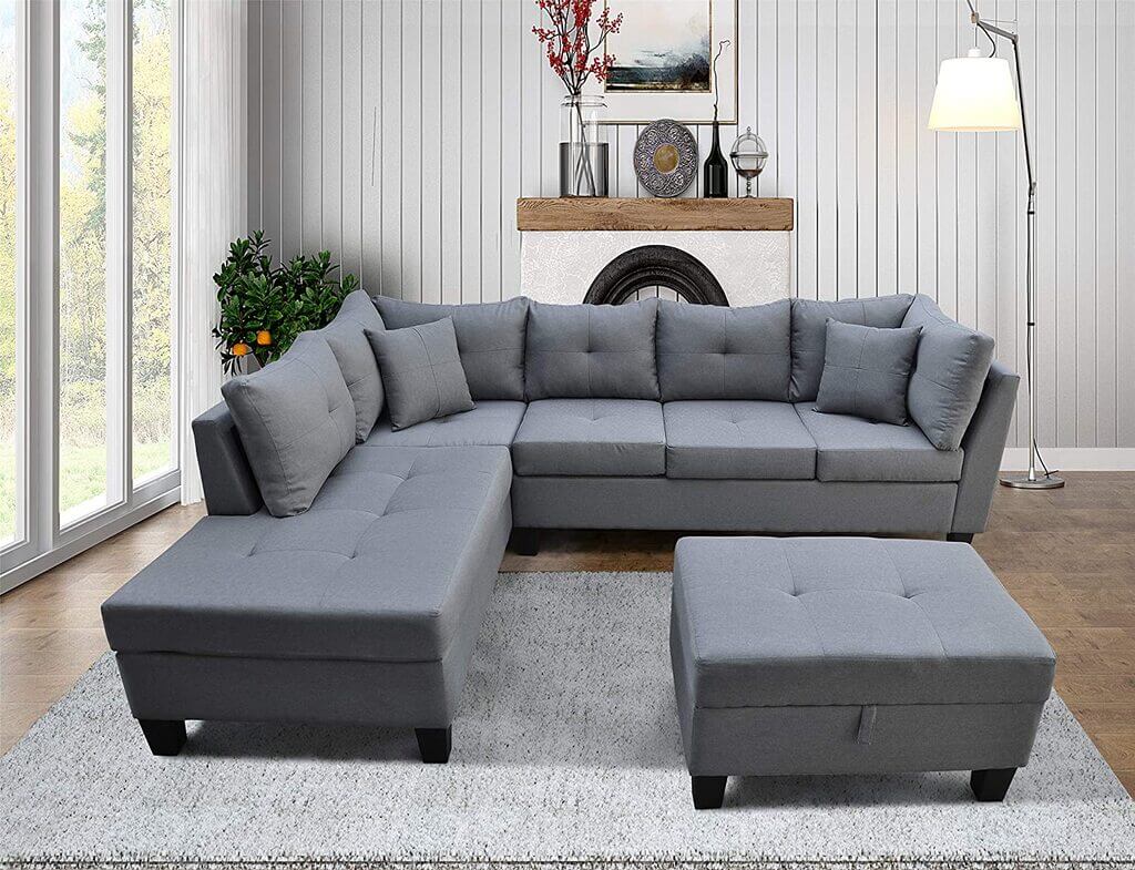 A living room with a sectional couch and ottoman
