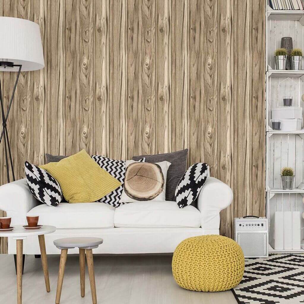 A living room with a white couch and a wooden wallpaper
