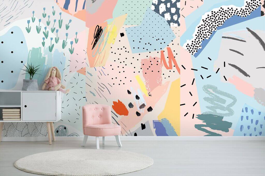 A pink chair in front of a colorful wall mural

