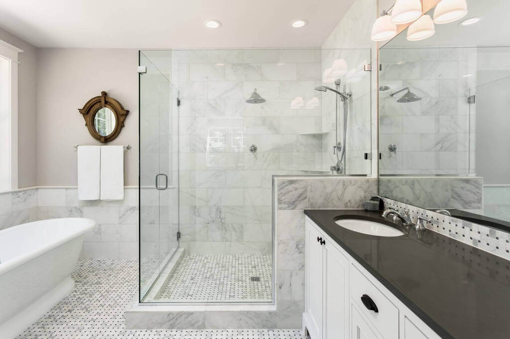 A large bathroom with a walk in shower next to a sink
