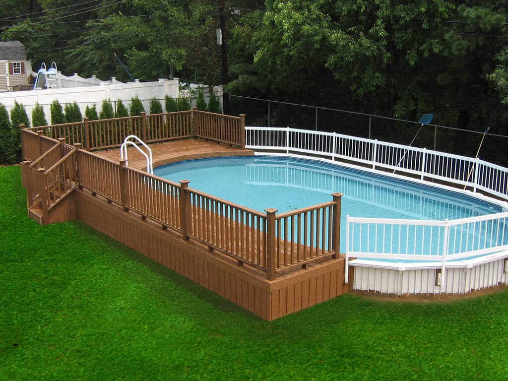 An above ground pool surrounded by a wooden deck
