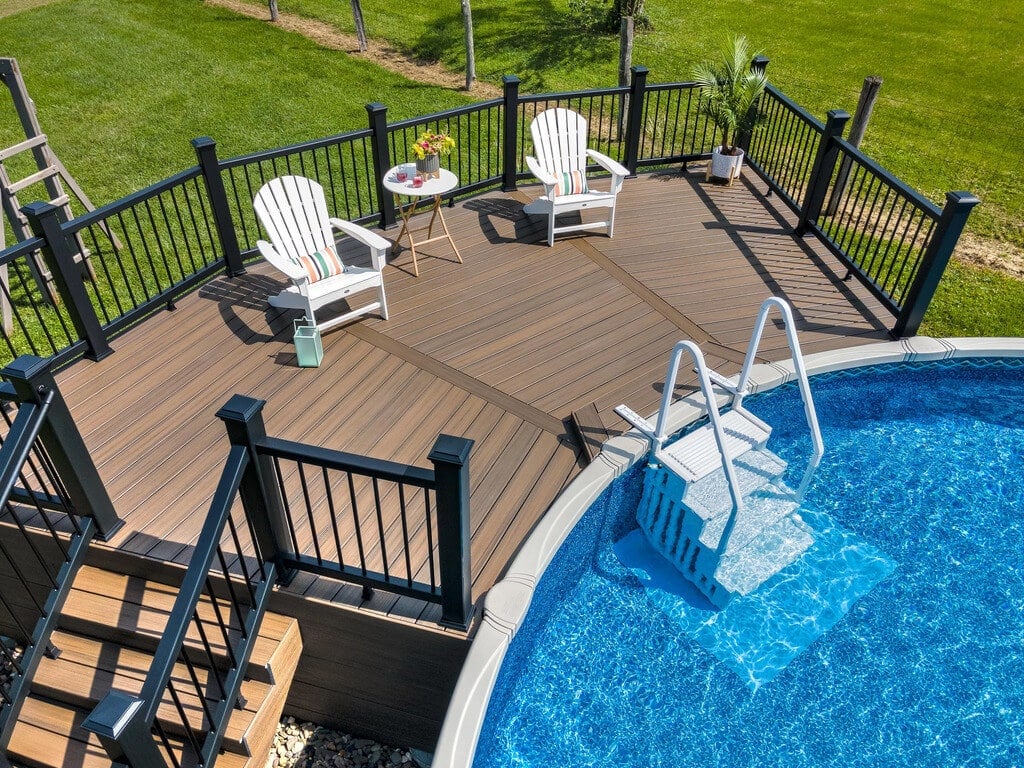 An above ground pool with a deck and chairs
