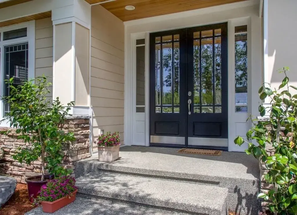 The front door of a house with two potted plants