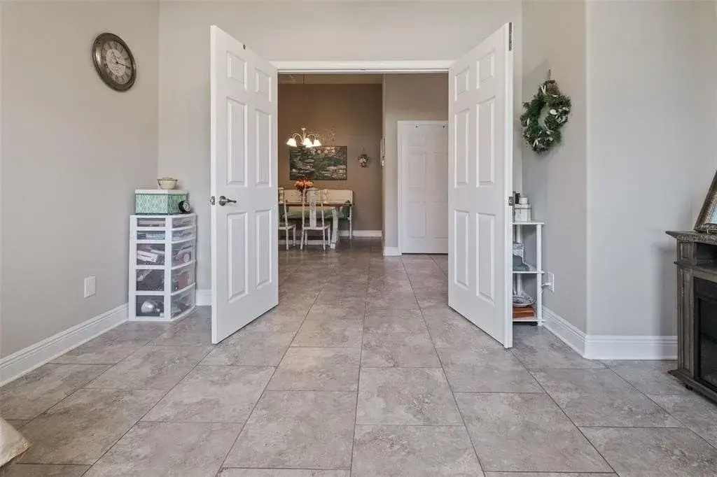 A living room filled with stone flooring and a fire place
