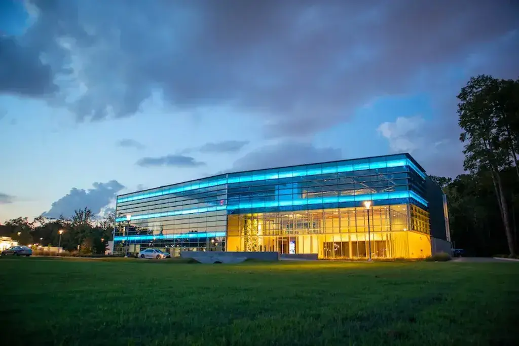 A large glass building lit up at night
