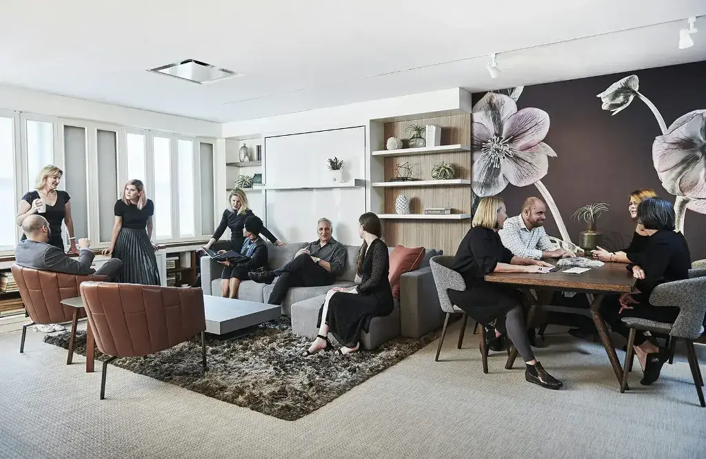 A group of people sitting around a living room together
