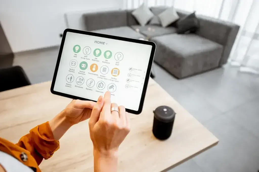 A person holding up a tablet with icons on it
