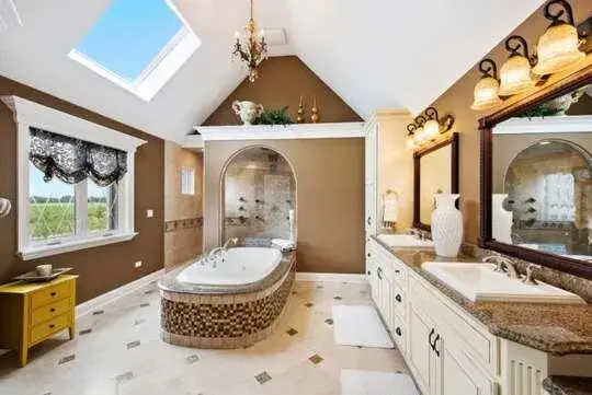 A large bathroom with a skylight above the tub
