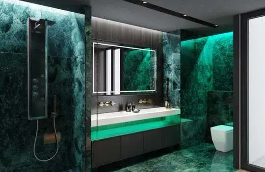 A bathroom with a green marble floor and walls
