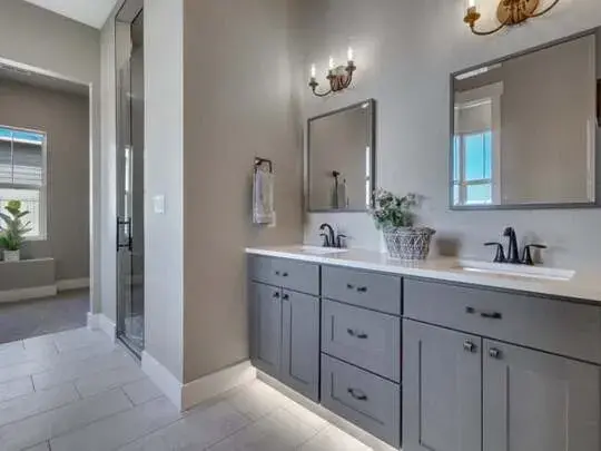 A large bathroom with two sinks and mirrors
