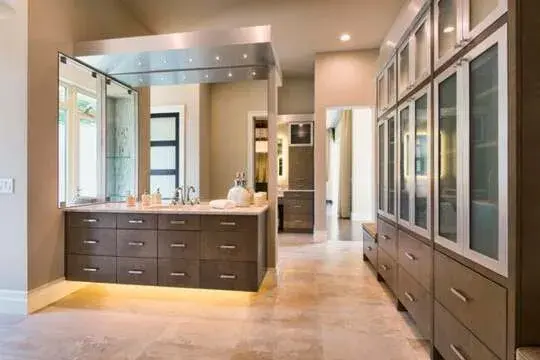 A large bathroom with double sinks and a large mirror

