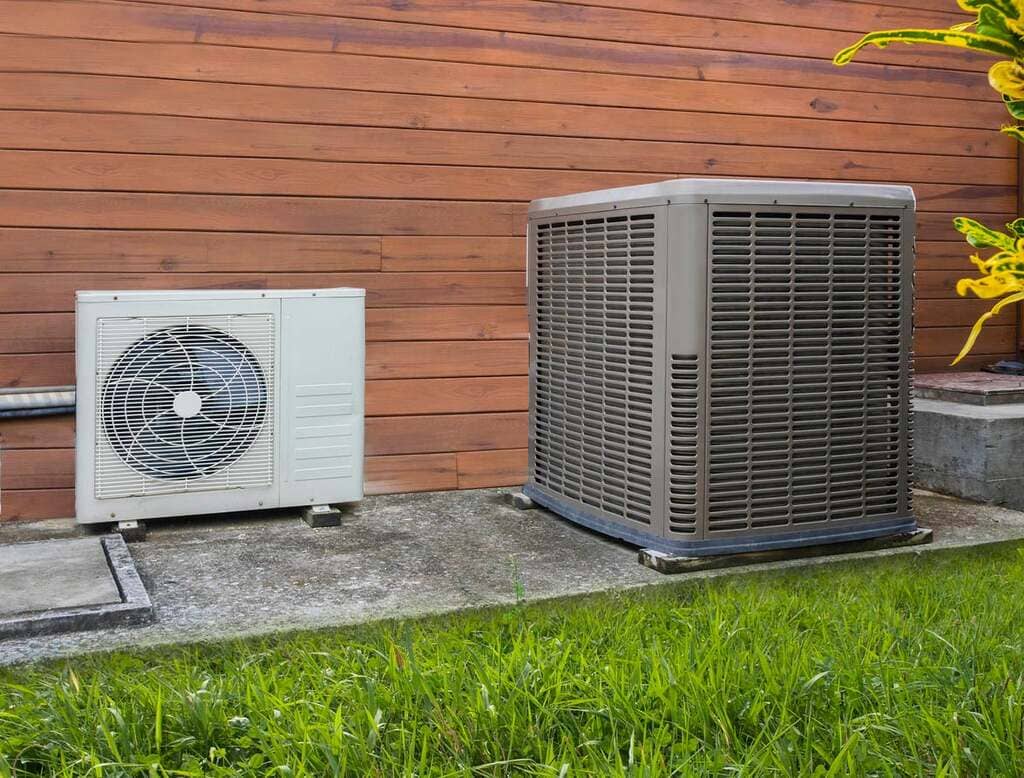 A couple of air conditioners sitting next to a building
