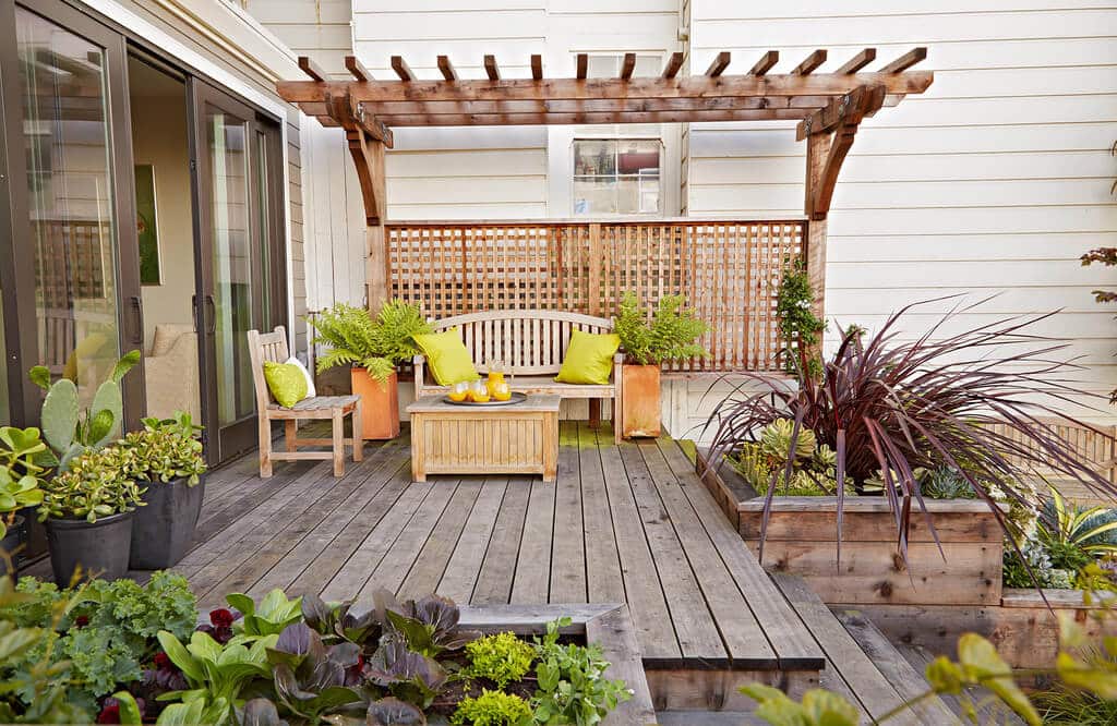 A wooden bench sitting on top of a wooden deck
