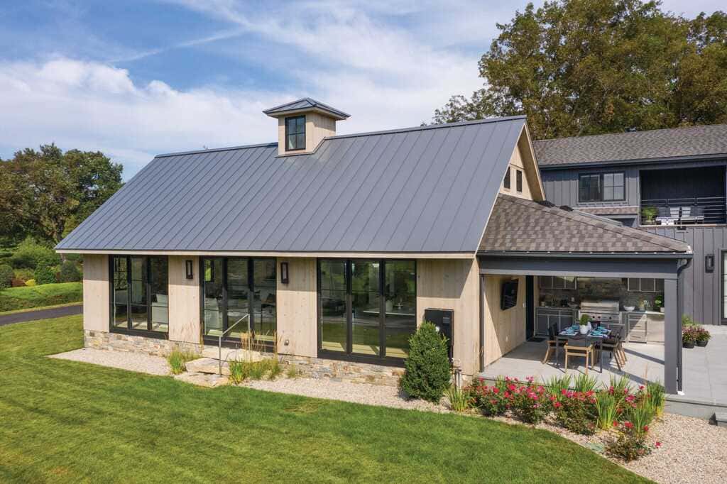 A house with a metal roof and a patio
