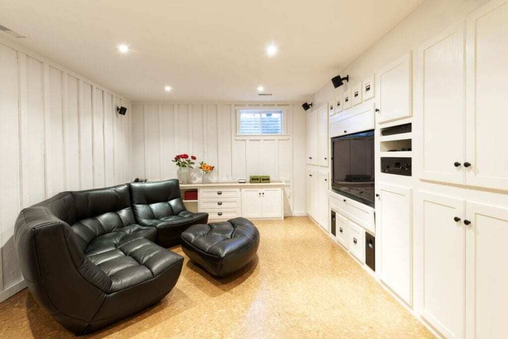 A living room with a couch a chair and a microwave
