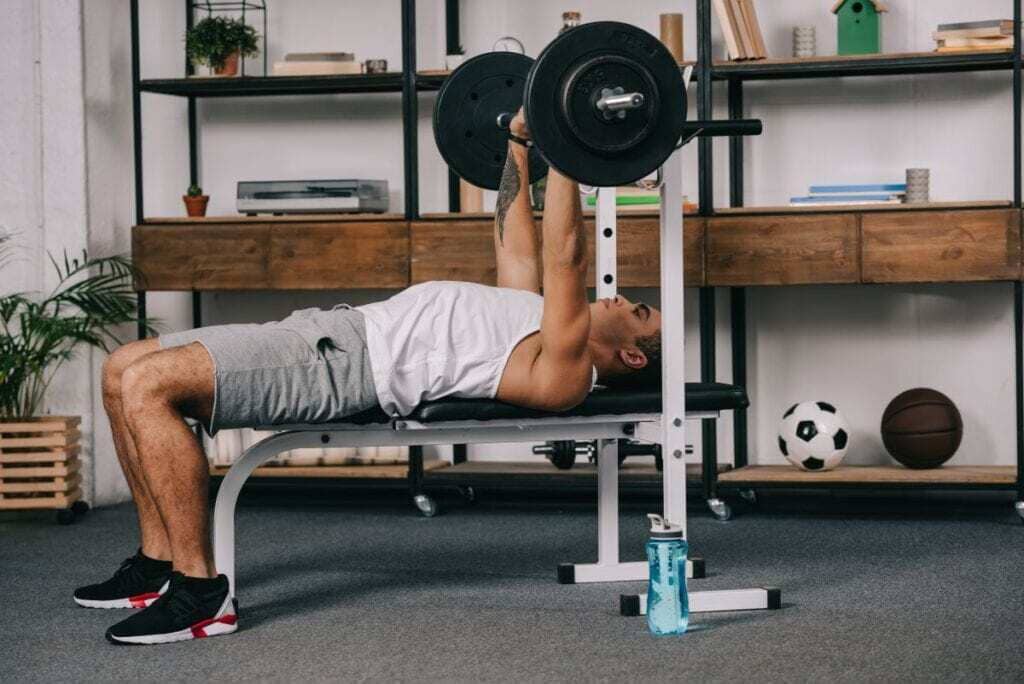 A man doing a bench press with a barbell
