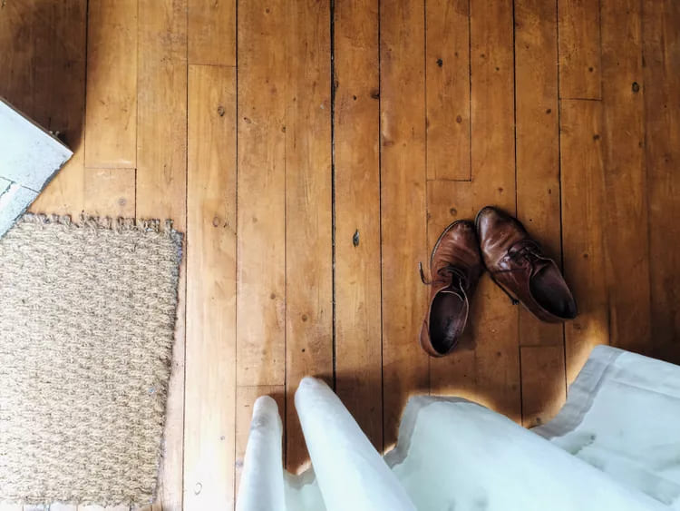 A pair of shoes sitting on top of a wooden floor
