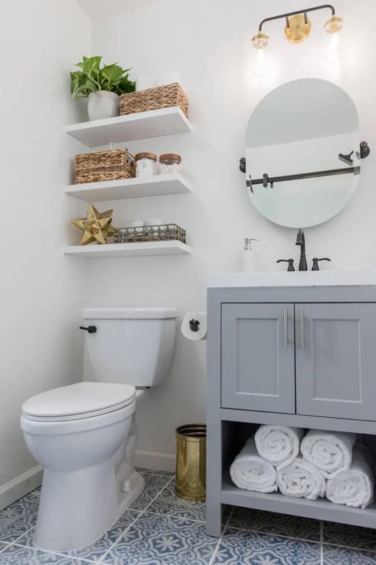 A white toilet sitting next to a bathroom sink
