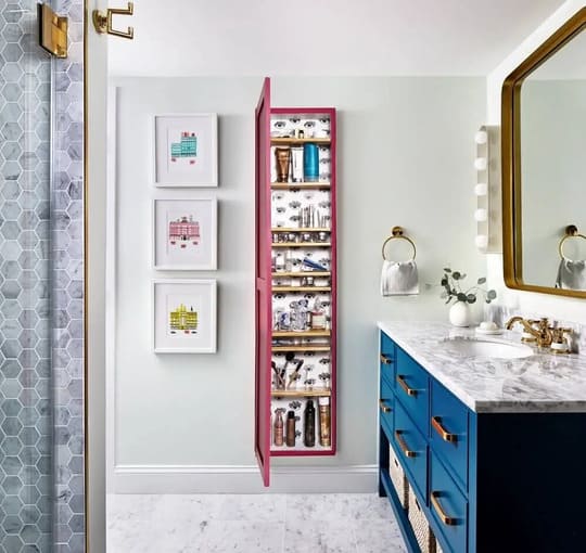 A bathroom with a blue cabinet and a mirror
