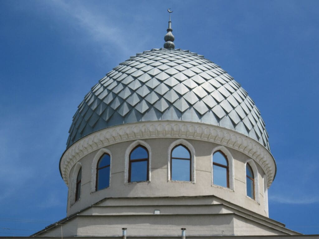 A large white building with a Domed Roof Designs
