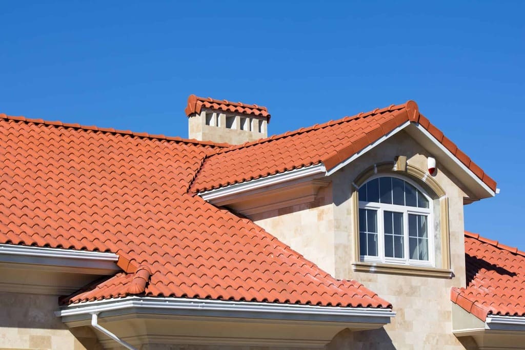 A house with a red roof and a blue sky
