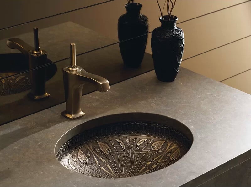 cast bronze under mount sink with plant
