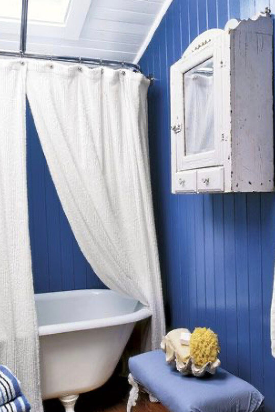 blue bathroom and white shower curtain