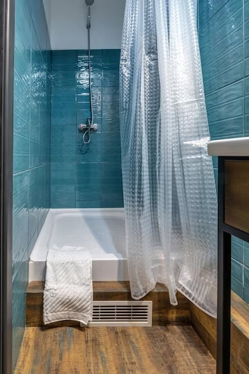 transparent shower curtain with blue tile